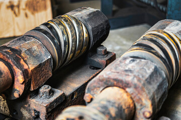 Used magnetic cylinder for rotary printing machine in plastic box. Magnetic shaft for die mounting. Selective focus.