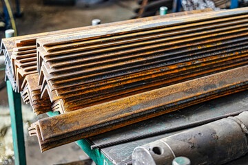 Blanks of metal corners at the factory for further processing. metal profile. Warehousing and storage of prepared elements for metalworking in a factory shop.