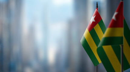 Small flags of the Togo on an abstract blurry background