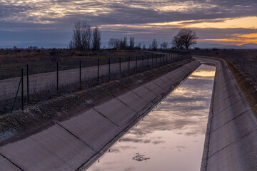 Landscape at sunset with the Páramo Bajo Canal Civil Engineering Work and the El Páramo Region, León, Spain.