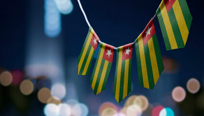 A garland of Togo national flags on an abstract blurred background