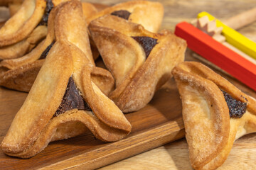 Traditional cookies Hamantaschen for Jewish holiday Purim on wooden background.