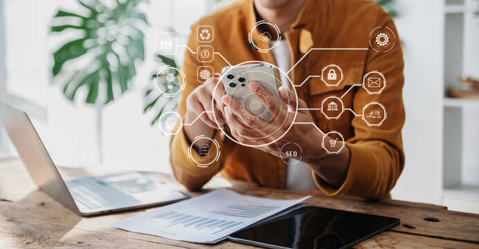 Businesswoman using smartphone and laptop and tablet computer with Digital marketing media in virtual icons interface.