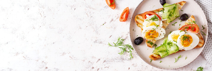 Healthy breakfast. Toast with feta cheese and egg. Healthy balanced food. Top view, banner