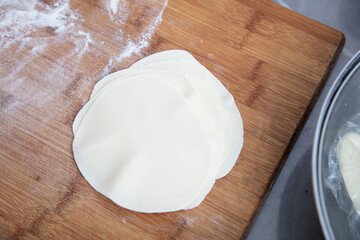 The rolled white dough is on the cutting board