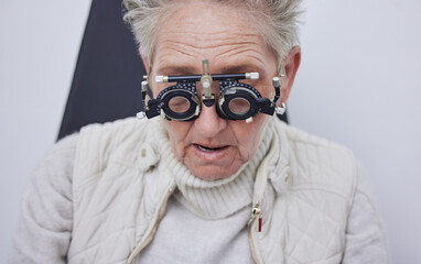 Eye exam, trial frame and senior woman in optometry clinic for vision test, eyesight and optical assessment. Ophthalmology, health and face of elderly patient with optician, optometrist and glasses