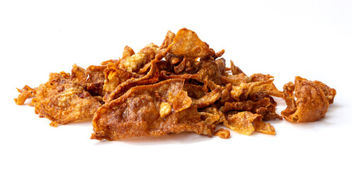 Crispy fried chicken skin on white background, snack food.