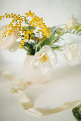 Obraz na płótnie Canvas a bouquet of spring flowers on a light background, Easter floristry