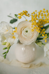 Obraz na płótnie Canvas a bouquet of spring flowers on a light background, Easter floristry