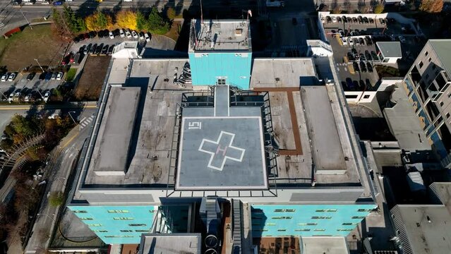 Helipad Sign On Rooftop Of Memorial Hospital In Surrey, British Columbia, Canada. - aerial ascend, pullback