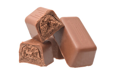 Milk chocolate pralines brocken into half with nougat filling isolated on white