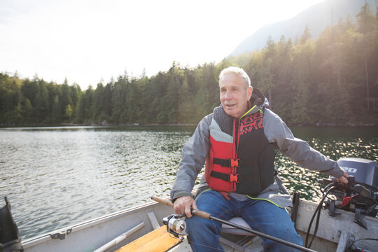 Fisherman sitting in motorboat, Hicks Lake, Harrison Hot Springs, British Columbia, Canada
