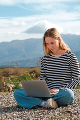 Remote work.Girl freelancer works remotely on the sea shore. workation, remote work,WFVH,Van Life vibes work from vacation home,work travel,remotely work.Travelling.Work from vacation remotely