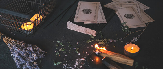 Esoteric, Occult mystical ritual scene of sorcery tarot candles, dried flowers, palo santo and tarot cards, ritual book. Witchcraft, mysticism and occultism,esoteric background