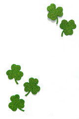 Happy St. Patrick's Day banner.Holiday background.St Patricks Day frame against a white background. Flat lay shamrocks.Copy space.Patrik's day banner