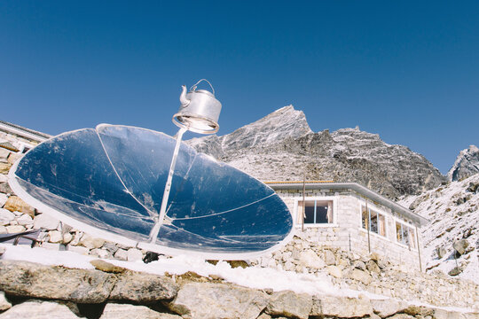 A reflector boils water in a kettle at high altitude in Nepal's Everest Region.