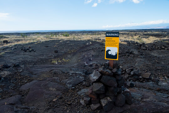 Tsunami warning sign in coastal volcanic landscape, Puna Coast Trail, Halape Beach, Hawaii Volcanoes National Park, Hawaii Islands, USA