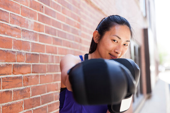 Woman with extended boxing glove, Boston, Massachusetts, USA