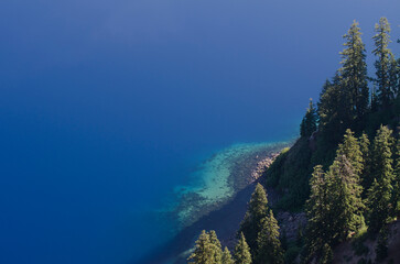 The crystal clear water shows the instant drop off at Crater Lake, the deepest lake in the USA at 1,943 feet.