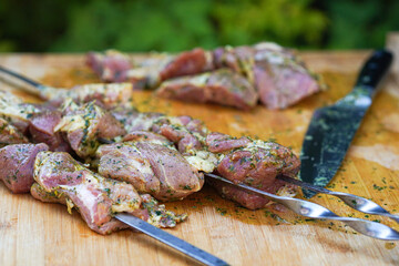    Summer barbecue cooking. Shashlik or shish kebab preparing on barbecue grill