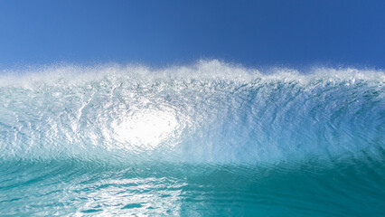 Wave Ocean Swimming Close Up Face To Face Encounter Blue Water Wall Crashing with Backlit Blue Sky.