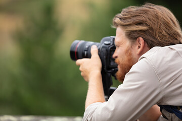 male photographer taking photos outdoors