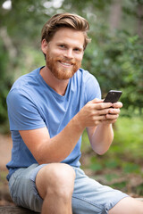 Fototapeta premium man with a backpack and a mobile phone