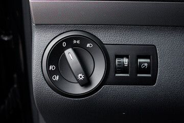 Close up of light control in car. Headlight switch, fog lights, automatic control of switching on...