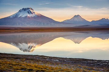 Salt lake Lejia reflection, idyllic volcanic landscape at Sunset, Atacama, Chile