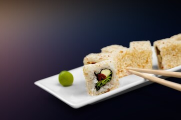 Wooden chopsticks and tasty fresh sushi dish