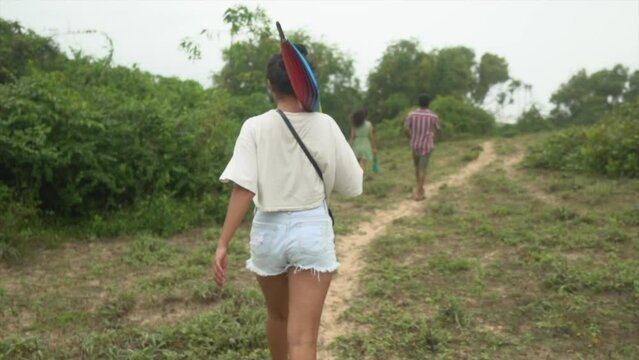 Young woman walking green field meadows in India