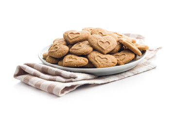 Sweet gingerbread hearts on plate isolated on white background.