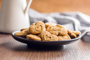 Sweet gingerbread hearts on plate.