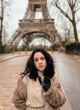 Lady near Eiffel Tower in Paris, France was made in winter. No snow, only some rain on the street. 