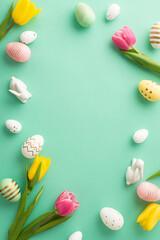 Fototapeta na wymiar Easter celebration concept. Top view vertical photo of ceramic easter bunnies tulips and colorful easter eggs on isolated teal background with copyspace in the middle