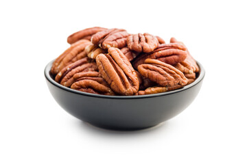 Peeled pecan nuts in bowl isolated on white background.