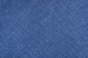 Jacquard woven upholstery, bright blue coarse fabric texture with diagonal weave lines. Textile background, furniture textile material, wallpaper, backdrop. Cloth structure close up.