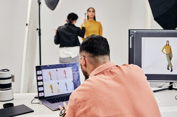 Laptop, photography editor and model in studio with photographer and shooting fashion design...