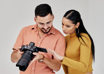 Teamwork, photographer and startup with camera in studio for shoot, magazine project or online content review. Digital agency, collaboration or people working on marketing or advertising campaign