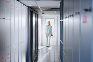 Fototapeta premium A female doctor came to the locker room after a working day.
