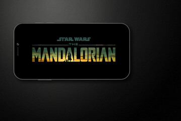 Naklejka premium The Mandalorian logo on smartphone screen. Moscow, Russia - February, 2023.
