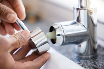 Plumber, hands and faucet, plumbing and maintenance with man, manual labour closeup and home...