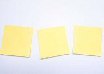 Isolated shot of blank yellow sticky note on white background