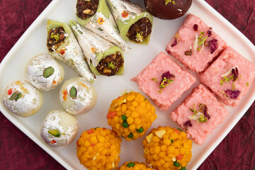 Variety Of Assorted Desi Ghee Indian Mithai viz. Laddu, Kesar Barfi, Kalakand, Kaju Barfi, Gulab Jamun. Traditional Sweet Food for Diwali, Holi, Rakshabandahan, Navaratri, Dussehra, Janmashtami Puja