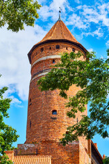 Olsztyn, Poland, August 10, 2022. main tower in the castle of the Warmia Chapter. The castle was erected in a naturally defensive place, on a hill in a wide bend of the Lyna River.