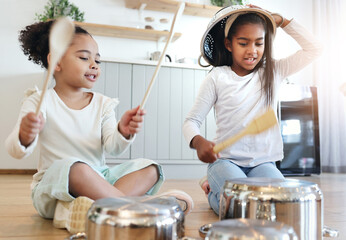 Girl children, kitchen and drums with pot in black family home, happiness and comic bonding on...