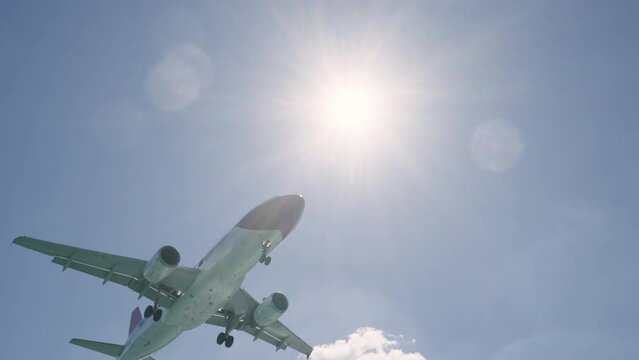 Amazing cinematic shot of large passenger airplane landing in Corfu Greece airport backlit by summer sun, slow motion