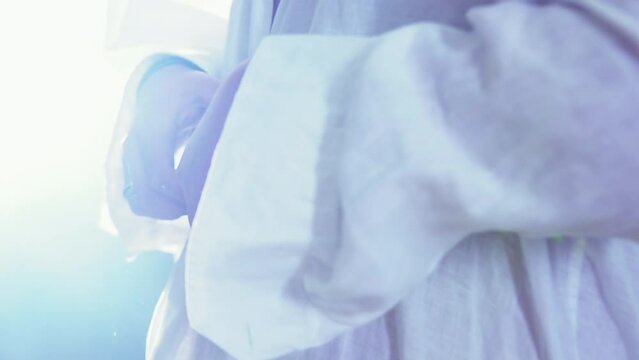 Cinematic close-up shot of an LGBT man seductively unbuttoning his shirt