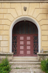 Fototapeta na wymiar old door on the vintage facade. architectural element