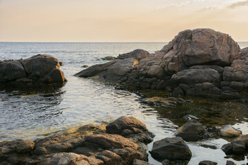 Fototapeta na wymiar seashore with rocks at sunrise